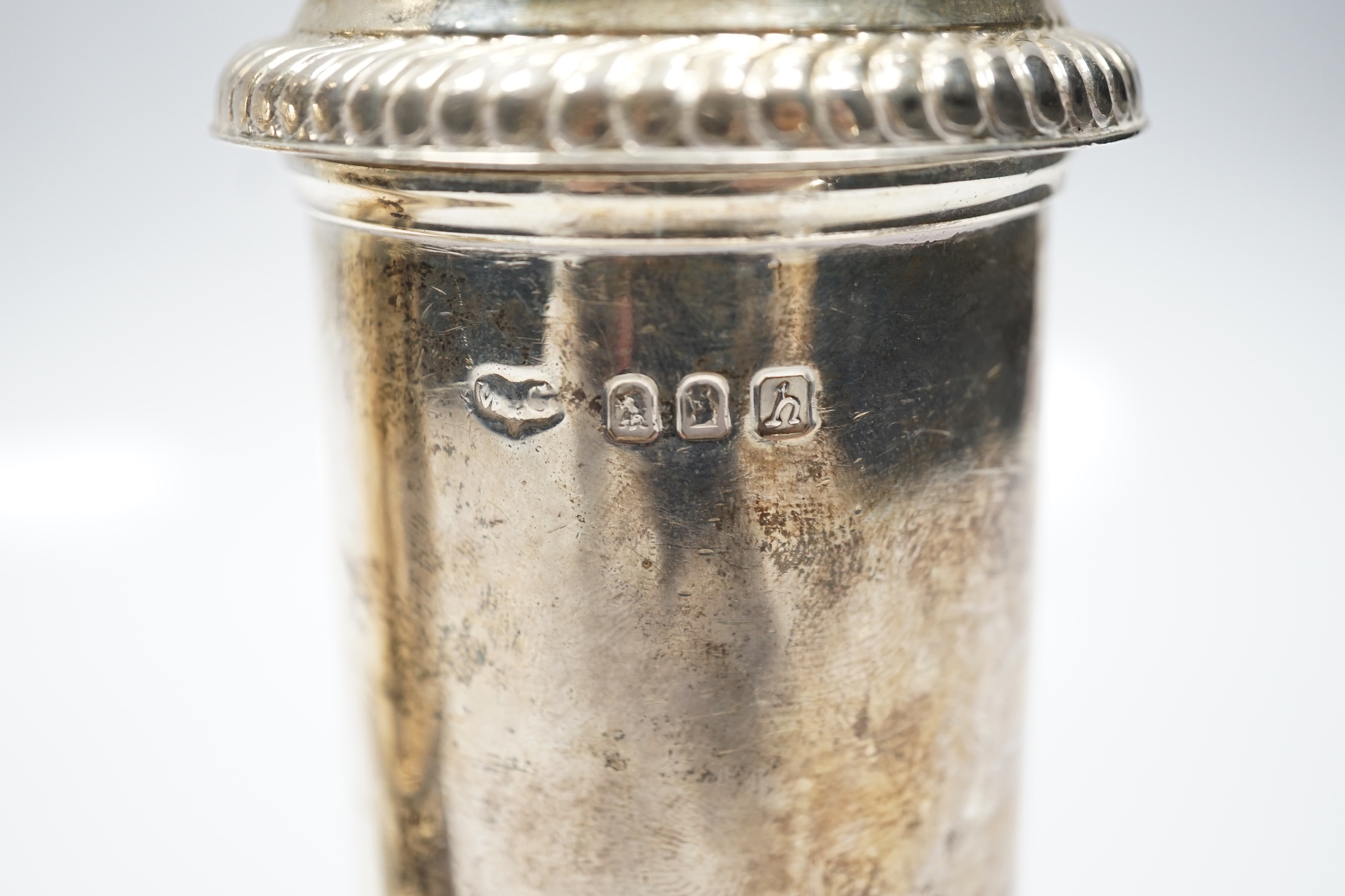 A matched pair of Britannia standard silver lighthouse sugar casters, Carrington & Co, London, 1903 and Wilson & Gill, London, 1963, 20.8cm, 22.6oz.